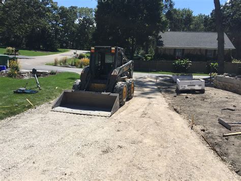 Stone driveway with skid steer 